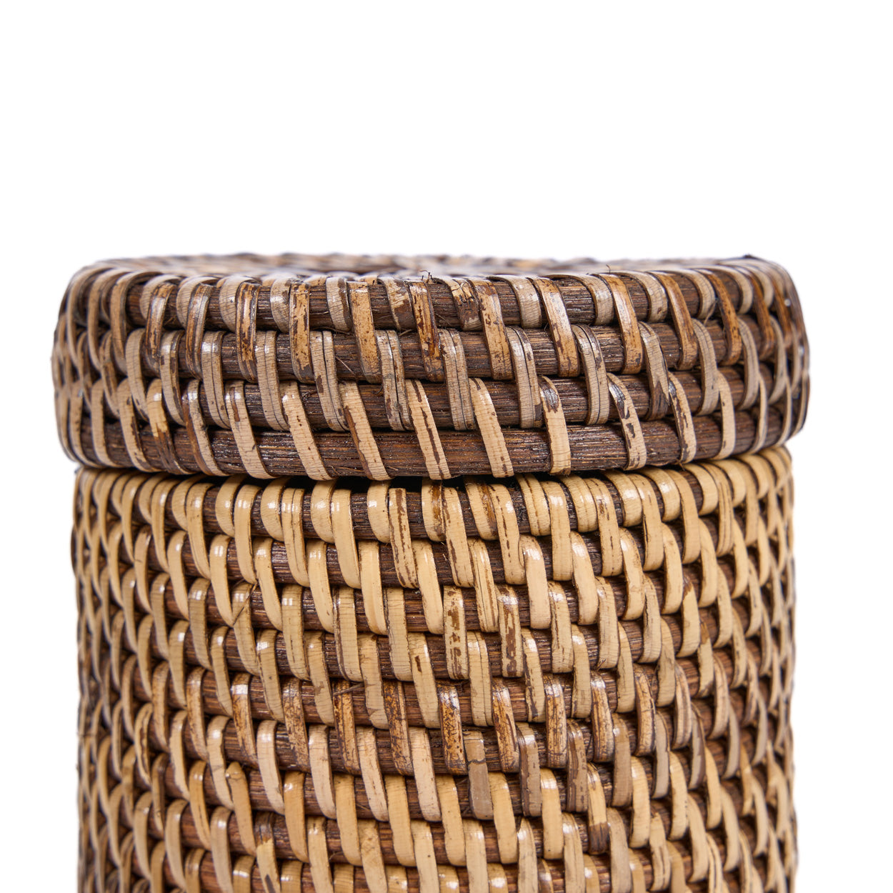 Woven rattan basket with a lid on a white background