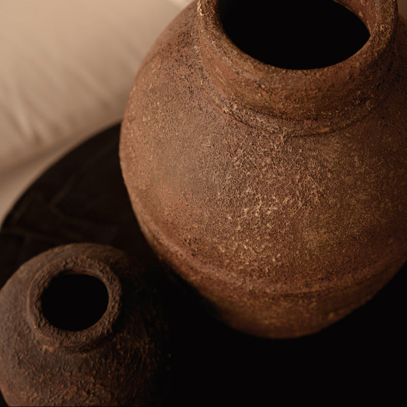 Two rustic vases on a biege background