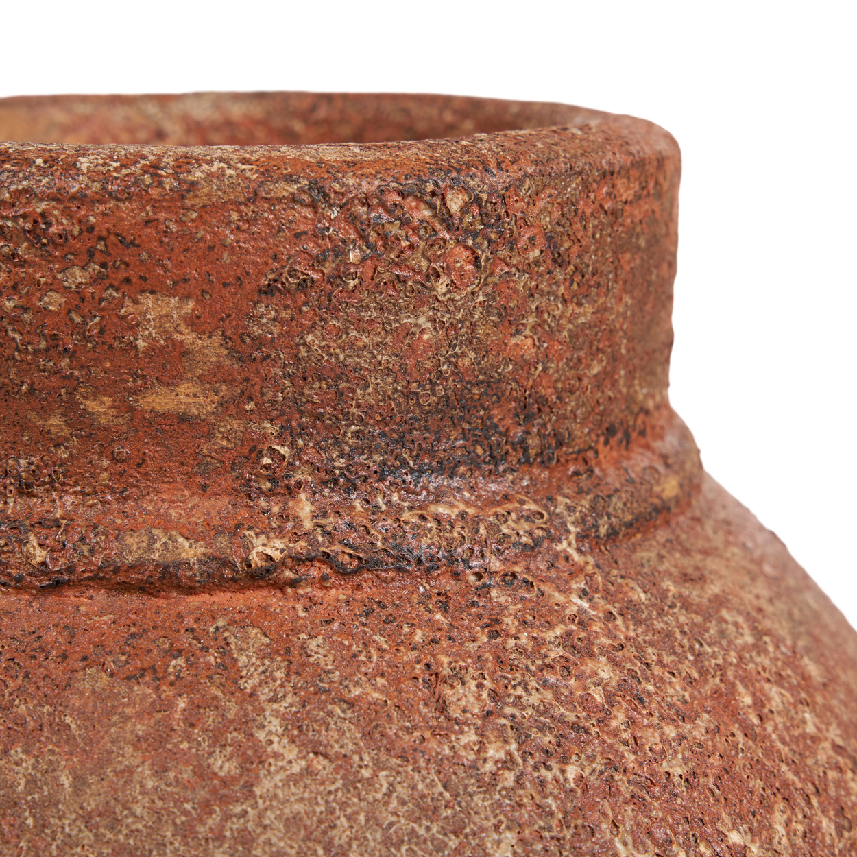 Close-up of a brown pot with a textured surface on a white background