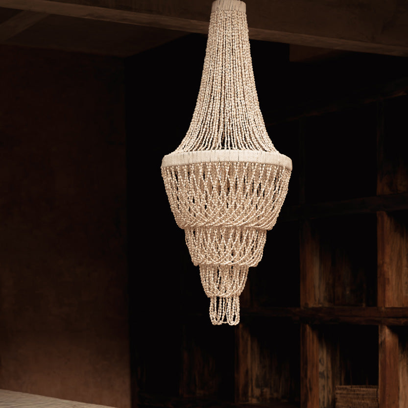 Natural colour woven chandelier hanging in a room with wooden shelves.