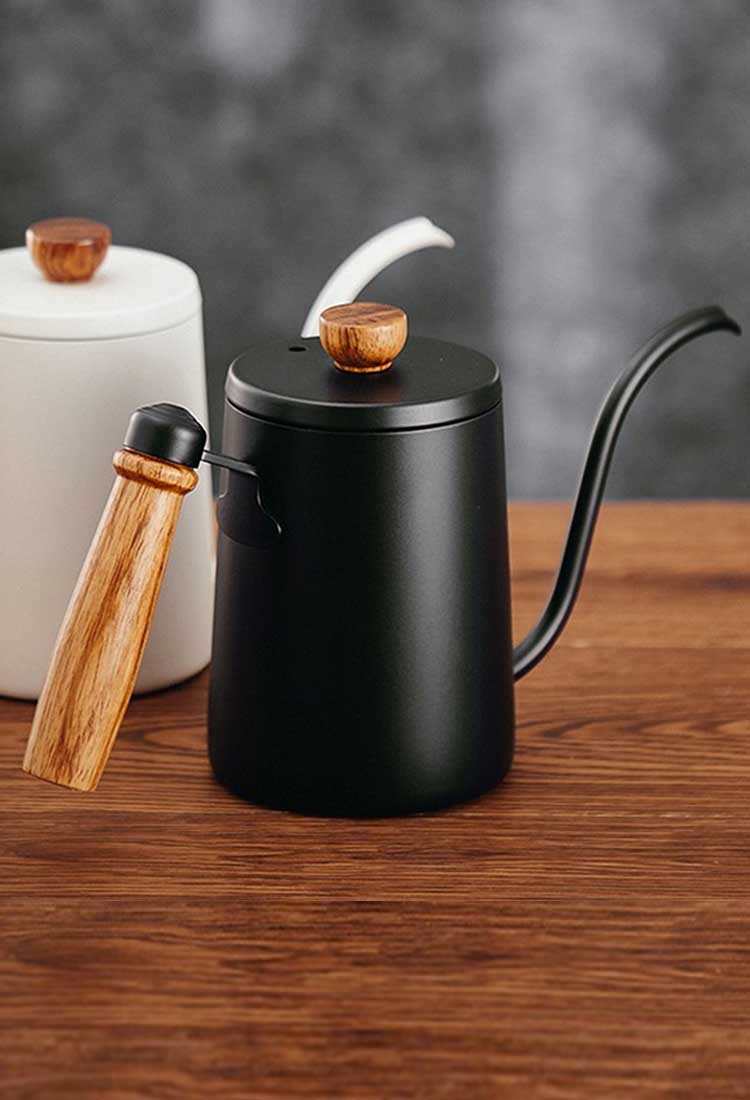 Handmade teapots with a wooden handle and a narrow neck