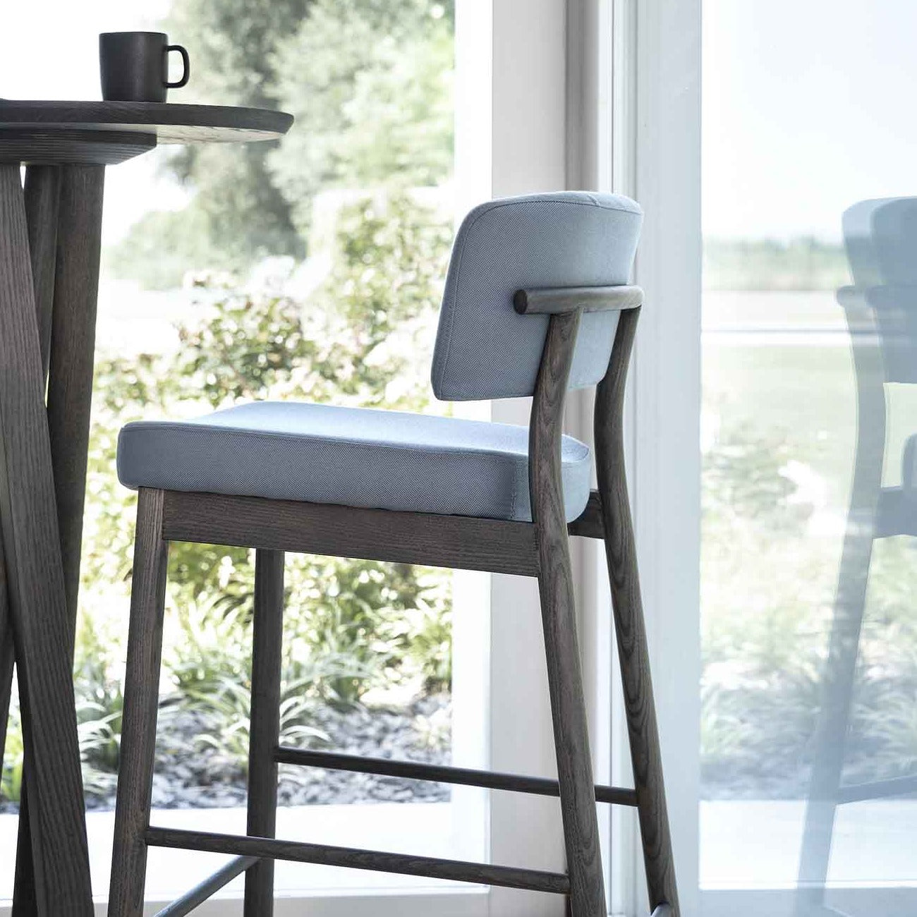 MARLEN Stool mahogany frame, blue upholstery interior crop view