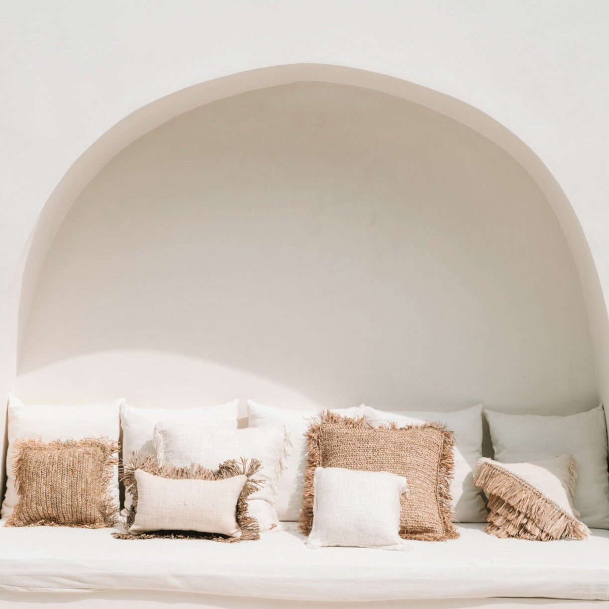 THE RAFFIA COTTON Cushion Cover outdoor view white wall background