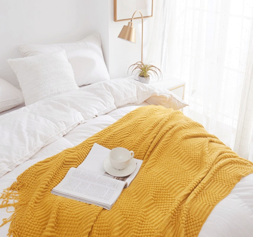 Decorative Knitted Blanket with Tassels yellow at the bed