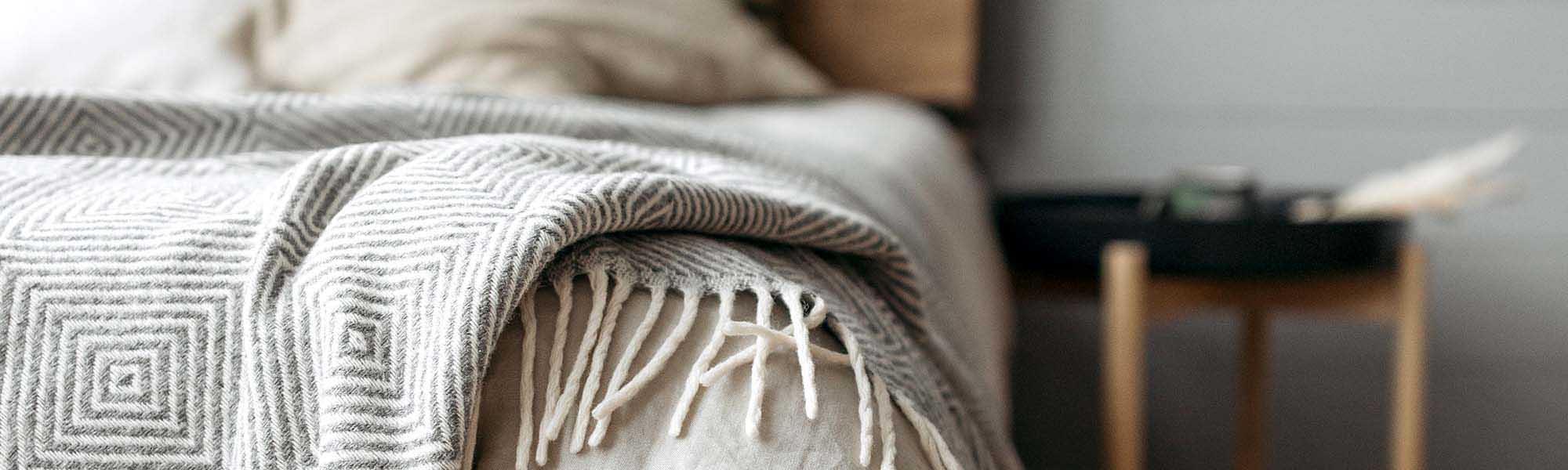 Light gray handmade blanket, woven from natural threads