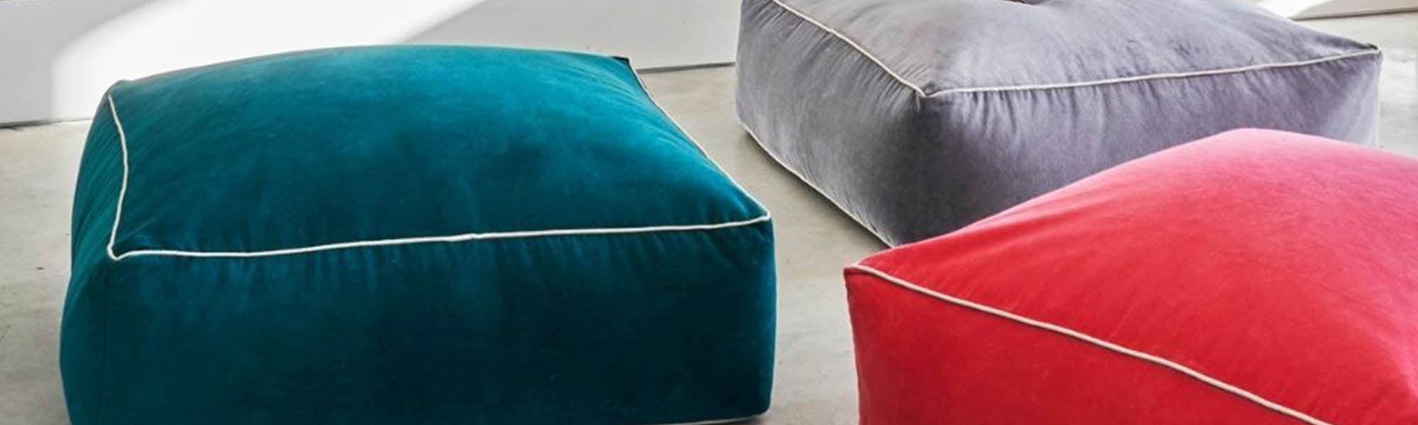 Turquoise, red and gray upholstered pouffes