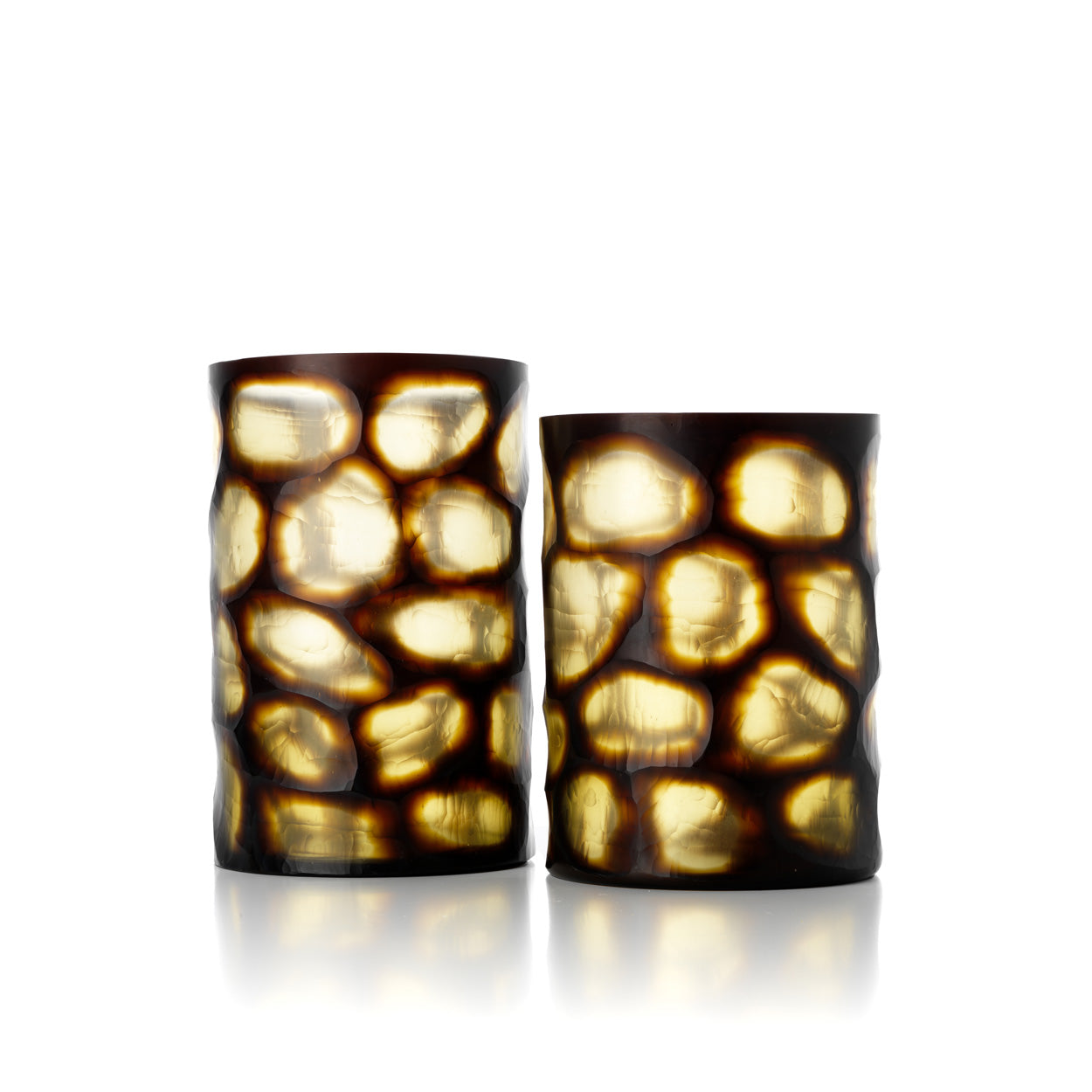 Two cylindrical glass vases with a textured, honeycomb-like design on a white background
