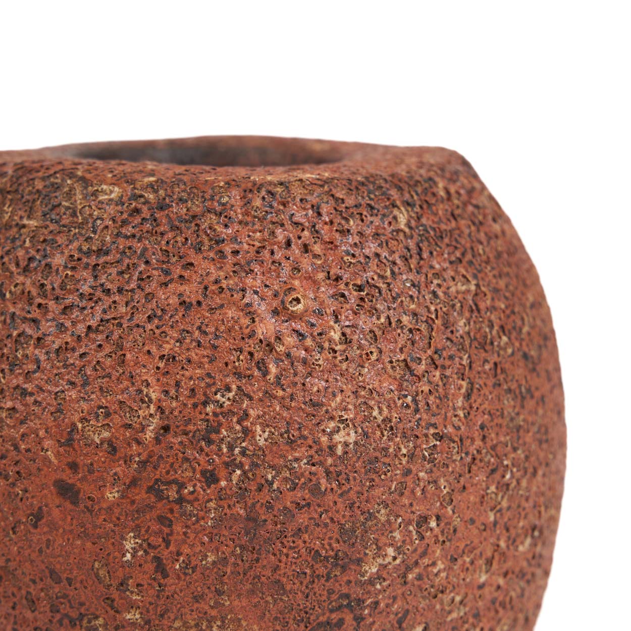 Close-up of a textured brown candle holder on a white background
