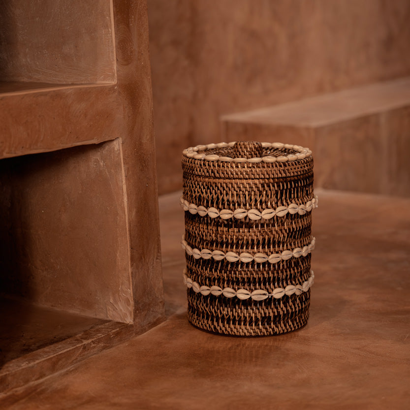 Woven rattan basket on a textured brown surface