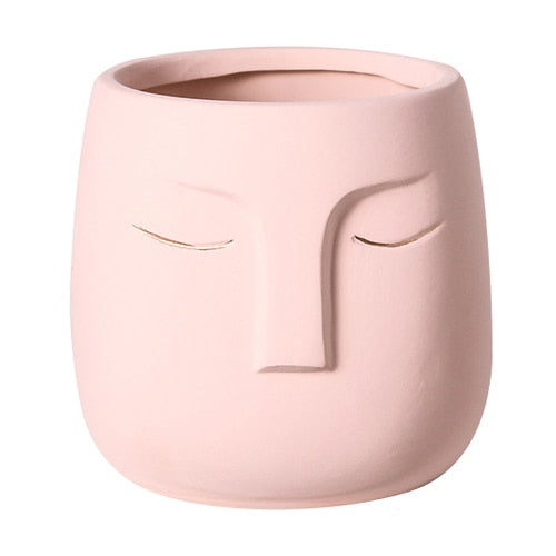 Pot de fleurs en céramique avec tête de visage
