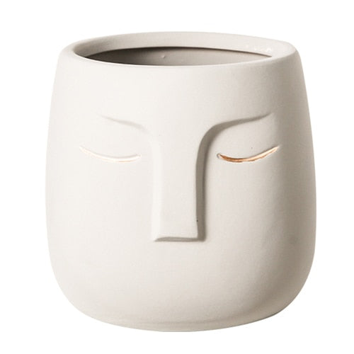 Pot de fleurs en céramique avec tête de visage